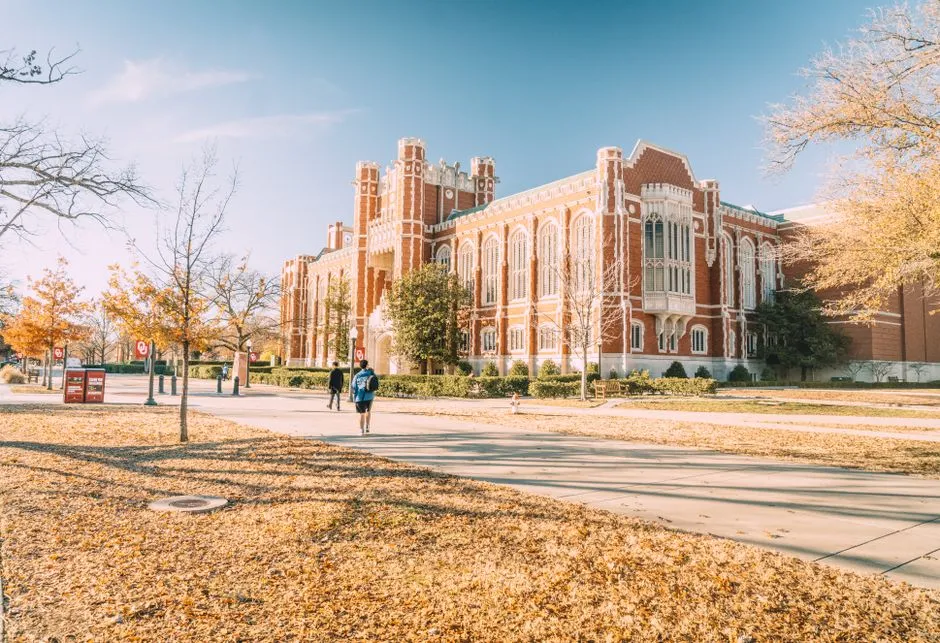 A U.S. college campus building surrounded by trees and lawn